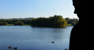 Woman beside a lake