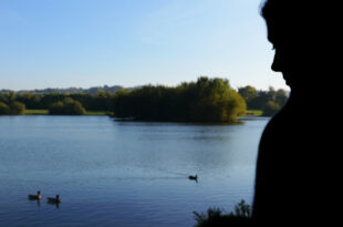 Woman beside a lake