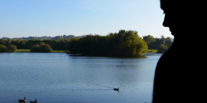 Woman beside a lake