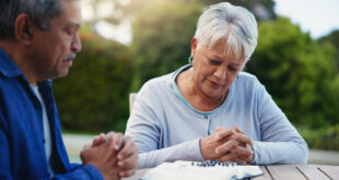 Old couple praying, planning